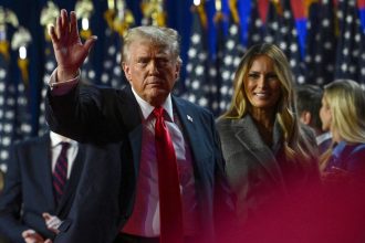 President-elect Donald Trump waves while walking off stage following early results from the 2024 presidential election in Palm Beach County Convention Center, in West Palm Beach, Florida, on November 6.