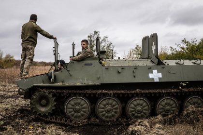 Two Ukrainian army mechanics repair a broken MT-LB (light armored multi-purpose towing vehicle) in the Donetsk region in Kharkiv, Ukraine on October 25, 2024.