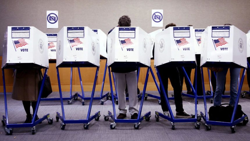 Voters fill out their ballots at a polling station in New York City on Election Day, November 5.