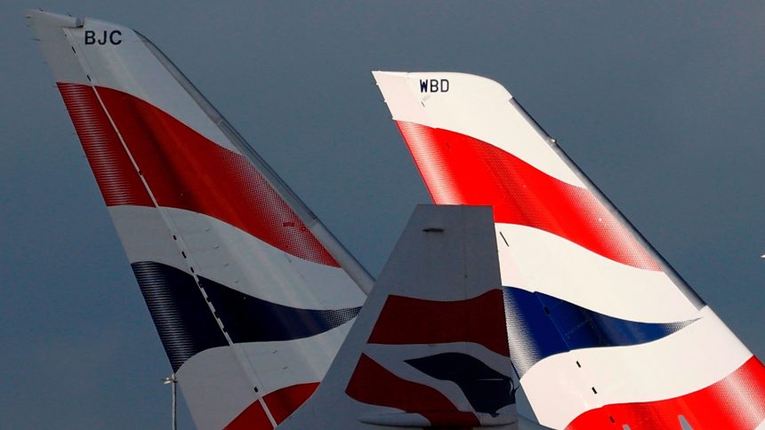 Sunlight illuminates the tailfins of British Airways aircraft at Terminal 5 of London Heathrow Airport on February 5, 2021