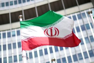 The flag of Iran is seen in front of the building of the International Atomic Energy Agency (IAEA) Headquarters on May 24, 2021 in Vienna, Austria.