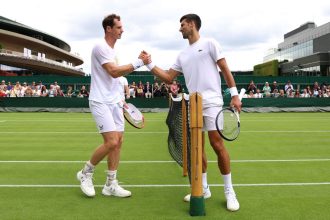 Andy Murray and Novak Djokovic shake hands after a practice session at Wimbledon in 2023.