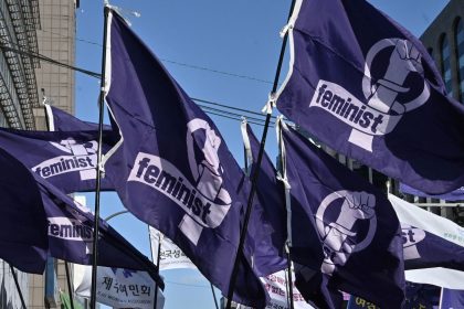 South Korean women carry flags reading "feminist" during a rally in Seoul earlier this year to mark International Women's Day.