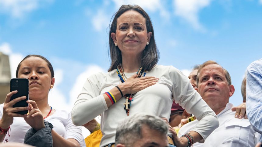 Opposition leader Maria Corina Machado looks on with a hand in her chest during a protest against the result of the presidential election on July 30, 2024 in Caracas, Venezuela.