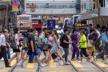 Pedestrians cross a street in Hong Kong on June 25, 2024.