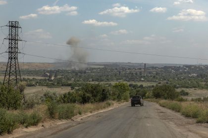 A vehicle drives as smoke rises from the town of Siversk, close to the frontline in the eastern Donetsk region.