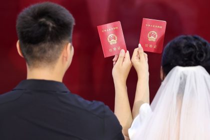 A newlywed couple pose for a photo at the marriage registration office Linyi, China on August 10, 2024.