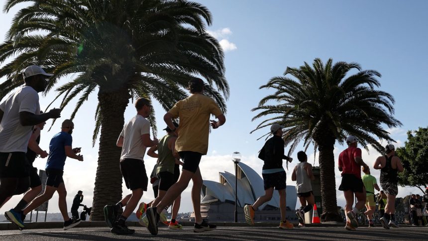 Participants of the Sydney marathon run towards the Opera House on September 15, 2024.