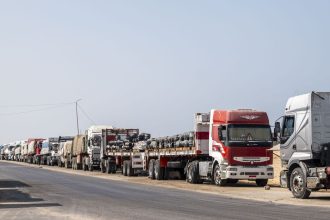 ARISH, EGYPT - OCTOBER 16: Trucks with aid destined for the Gaza Strip are parked on the side of the road on October 16, 2024 in Arish, Egypt. A UK delegation has visited the Al-Arish Hospital, where injured Palestinians are being treated, as well as a warehouse where humanitarian aid has been stored, since the Rafah crossing into Gaza was closed in May. (Photo by Ali Moustafa/Getty Images)