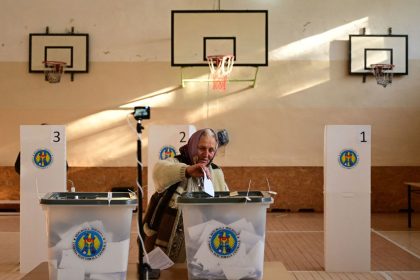 A woman casts her first-round ballot for the presidential election in Bulboaca, Moldova, October 20, 2024.