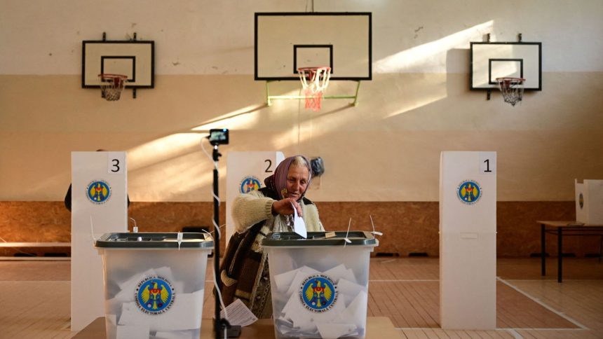 A woman casts her first-round ballot for the presidential election in Bulboaca, Moldova, October 20, 2024.