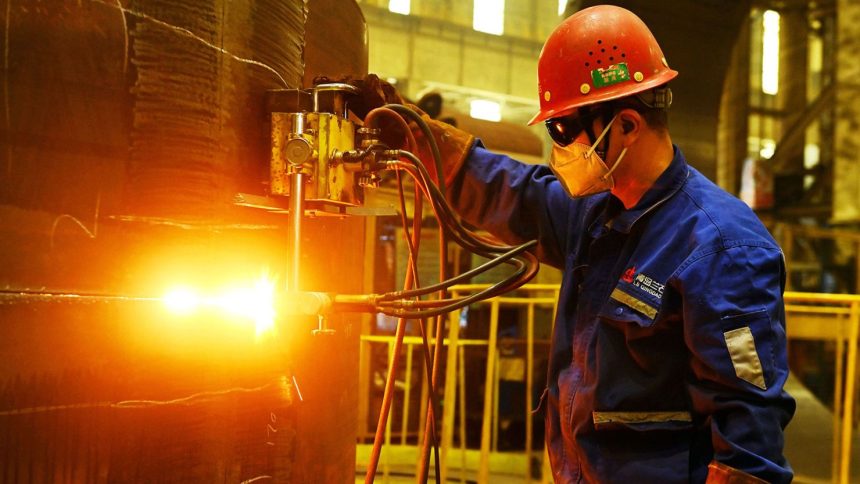 A worker builds petrochemical equipment parts at Lanshi Heavy Machinery in Qingdao, China, on October 31, 2024.