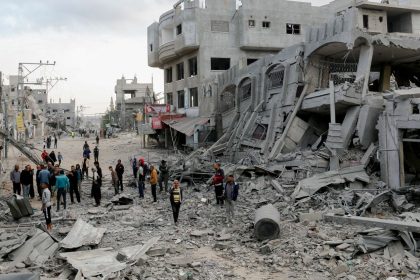 Residents walk through streets of rubble in the Al-Zawaida area of the Gaza Strip on November 1.