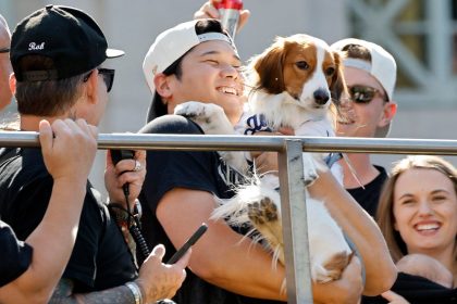 Shohei Ohtani celebrates on the bus with his dog Decoy during the Dodgers' victory parade.