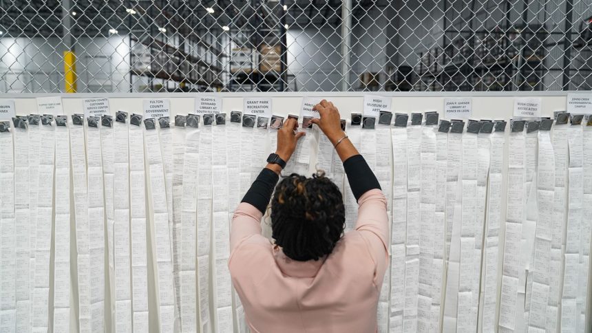 Receipts from early voting are being brought out during election night at the Fulton County Elections Hub and Operation Center in Fairburn, Georgia on November 5, 2024.