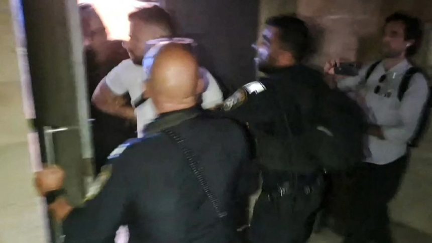 In a screen grab taken from an AFPTV video, Israeli police detain a French consulate staff officer at the  French-owned Eleona church compound in Jerusalem, on November 7, 2024.