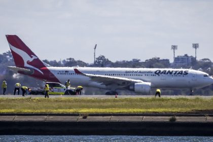 Workers check the runway at Sydney International Airport following an emergency landing by a Qantas plane (not the aircraft pictured here).