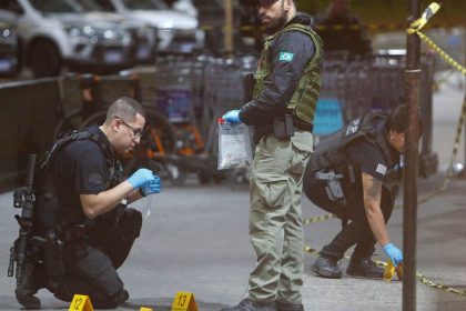 Police officers and forensic workers collect evidence at the scene of a shooting at Guarulhos international airport in Sao Paulo on November 8, 2024.