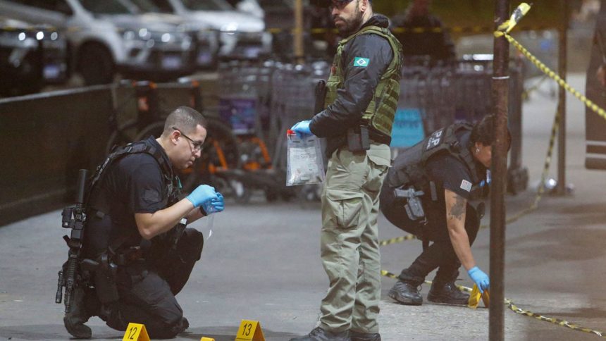 Police officers and forensic workers collect evidence at the scene of a shooting at Guarulhos international airport in Sao Paulo on November 8, 2024.