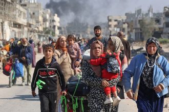 TOPSHOT - Palestinians displaced from shelters in Beit Hanoun cross the main Salaheddine road into Jabalia in the northern Gaza Strip following Israeli army evacuation orders on November 12, 2024, amid the ongoing war in the Palestinian territory between Israel and Hamas. (Photo by Omar AL-QATTAA / AFP) (Photo by OMAR AL-QATTAA/AFP via Getty Images)