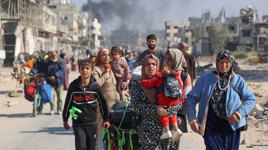 TOPSHOT - Palestinians displaced from shelters in Beit Hanoun cross the main Salaheddine road into Jabalia in the northern Gaza Strip following Israeli army evacuation orders on November 12, 2024, amid the ongoing war in the Palestinian territory between Israel and Hamas. (Photo by Omar AL-QATTAA / AFP) (Photo by OMAR AL-QATTAA/AFP via Getty Images)