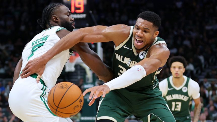 Giannis Antetokounmpo of the Milwaukee Bucks is defended by Jaylen Brown of the Boston Celtics during the first half of the game at Fiserv Forum.