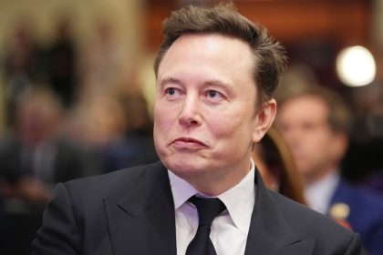 Elon Musk listens as US President-elect Donald Trump addresses a House Republican Conference meeting at the Hyatt Regency on Capitol Hill on November 13, 2024 in Washington, DC.