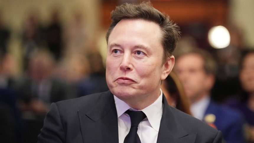 Elon Musk listens as US President-elect Donald Trump addresses a House Republican Conference meeting at the Hyatt Regency on Capitol Hill on November 13, 2024 in Washington, DC.