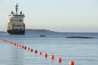 Submarine telecommunications cable being laid to the bottom of the Baltic Sea by cable laying ship "Ile de Brehat" off the shore of Helsinki.