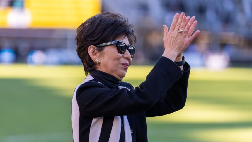 Washington Spirit owner Michele Kang waves to the crowd during a NWSL playoff semifinal game between NJ/NY Gotham FC and Washington Spirit at Audi Field on November 16.