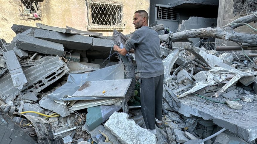 A Palestinian inspects the rubble of a building in Beit Lahia, in the northern Gaza Strip, on November 21, 2024, as the war between Israel and Palestinian Hamas militants continues.