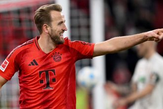 Harry Kane celebrates after scoring against Augsburg in Bayern Munich's 3-0 win.