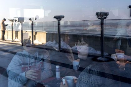 Customers inside the Starbucks coffee shop with views of North Korea on November 29.