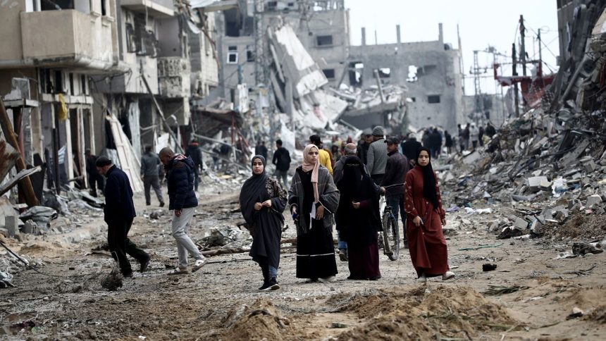 Palestinians return to Nuseirat in the central Gaza Strip following Israeli shelling.