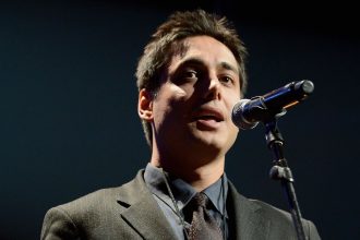 Iranian activist Kianoosh Sanjari speaks on stage at the Amnesty International Concert presented by the CBGB Festival at Barclays Center in New York City, on February 5, 2014.