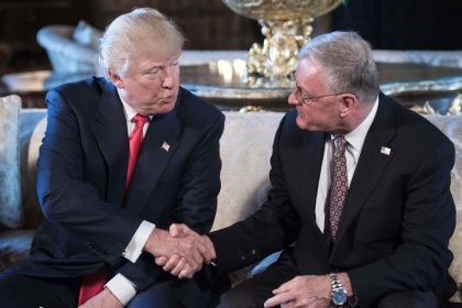 In this 2017 photo, Donald Trump shakes hands with Keith Kellogg in Florida.