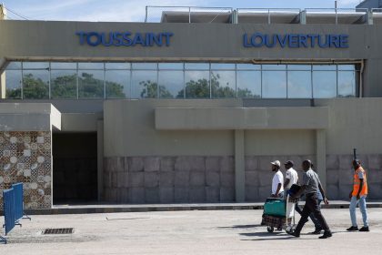 Travellers walk in front of the Toussaint Louverture International Airport in Port-au-Prince in May 2024.