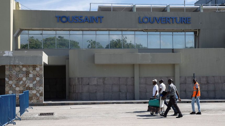 Travellers walk in front of the Toussaint Louverture International Airport in Port-au-Prince in May 2024.