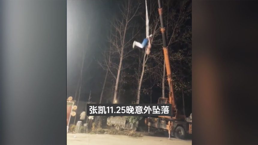 This screengrab shows Zhang Kai performing an ariel silk routine moments before the fabric snapped from the crane.