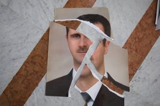 A torn portrait of Bashar al-Assad, which appears to have been arranged, is seen inside the Presidential Palace in Damascus, Syria, on December 10, 2024.