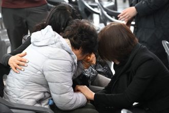 Relatives of passengers who died in the Jeju Air crash mourn their loved ones at Muan International Airport on December 30.