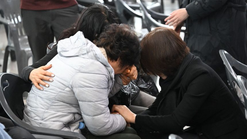 Relatives of passengers who died in the Jeju Air crash mourn their loved ones at Muan International Airport on December 30.