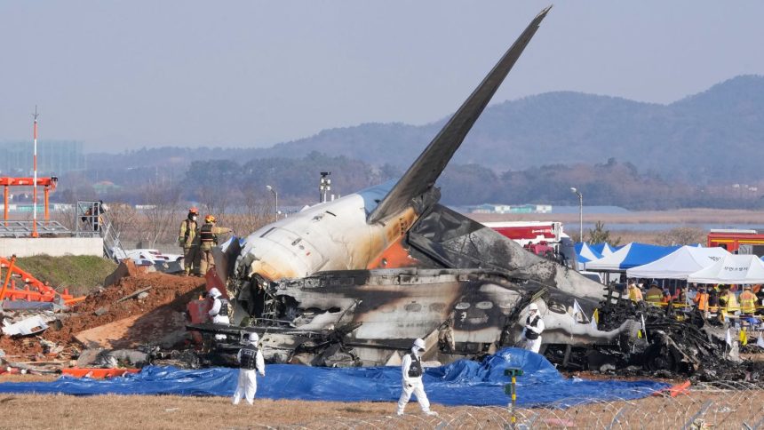 Firefighters and rescue team members work near the wreckage of a passenger plane at Muan International Airport in South Korea on December 29, 2024.