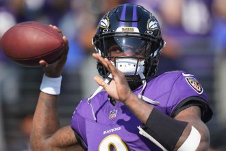 Baltimore Ravens quarterback Lamar Jackson warms up prior to the game against the Washington Commanders at M&T Bank Stadium on October 13.