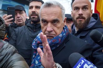 Calin Georgescu, center, an independent candidate for president who won the first round of Romania's presidential election, pictured in Mogosoaia, Romania, on December 8, 2024.