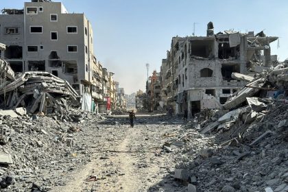 A Palestinian man walks among a valley of rubble in Beit Lahiya, after the Israeli military withdrew from the area around Kamal Adwan Hospital, in northern Gaza, on October 26.