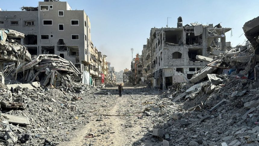 A Palestinian man walks among a valley of rubble in Beit Lahiya, after the Israeli military withdrew from the area around Kamal Adwan Hospital, in northern Gaza, on October 26.