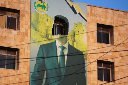 A damaged poster of Syrian President Bashar al-Assad in Aleppo.