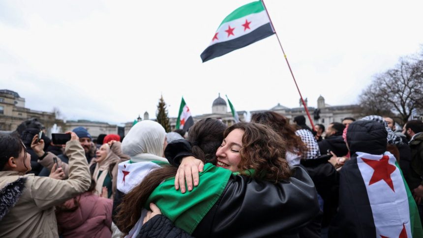 People embrace as they gather in Trafalgar Square, after Syrian rebels announced that they have ousted Syria's Bashar al-Assad, in London, Britain December 8, 2024. REUTERS/Mina Kim TPX IMAGES OF THE DAY