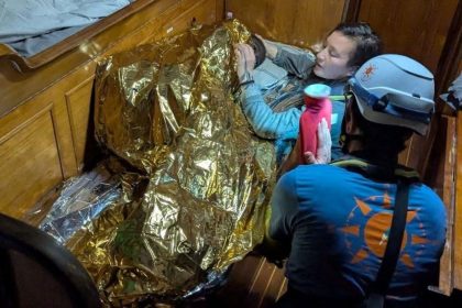 A volunteer assists an 11-year-old girl from Sierra Leone, the sole survivor of a shipwreck off Italy's Lampedusa Island on Wednesday.